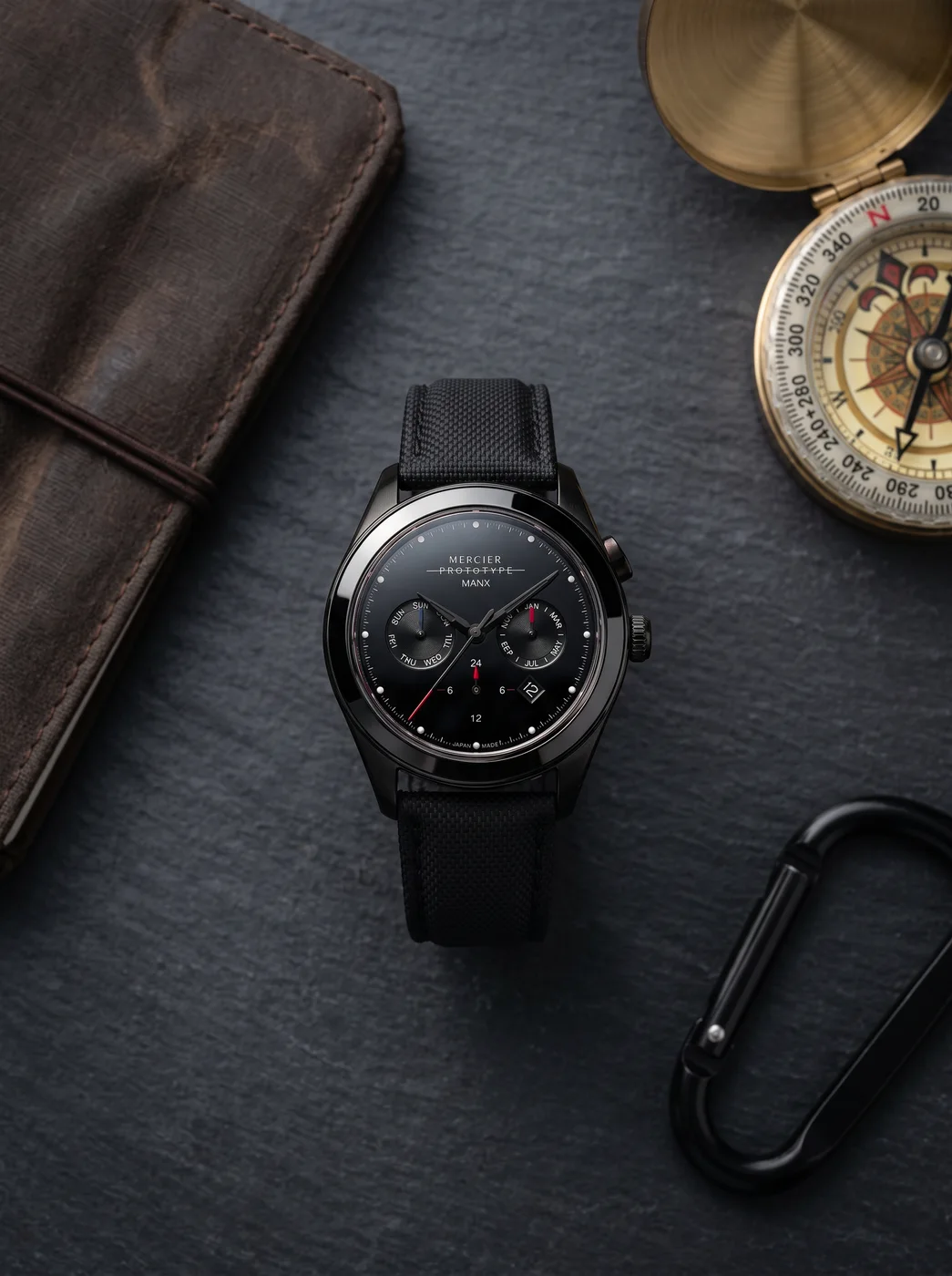 Manx Meridian Noir flat lay on slate with field kit