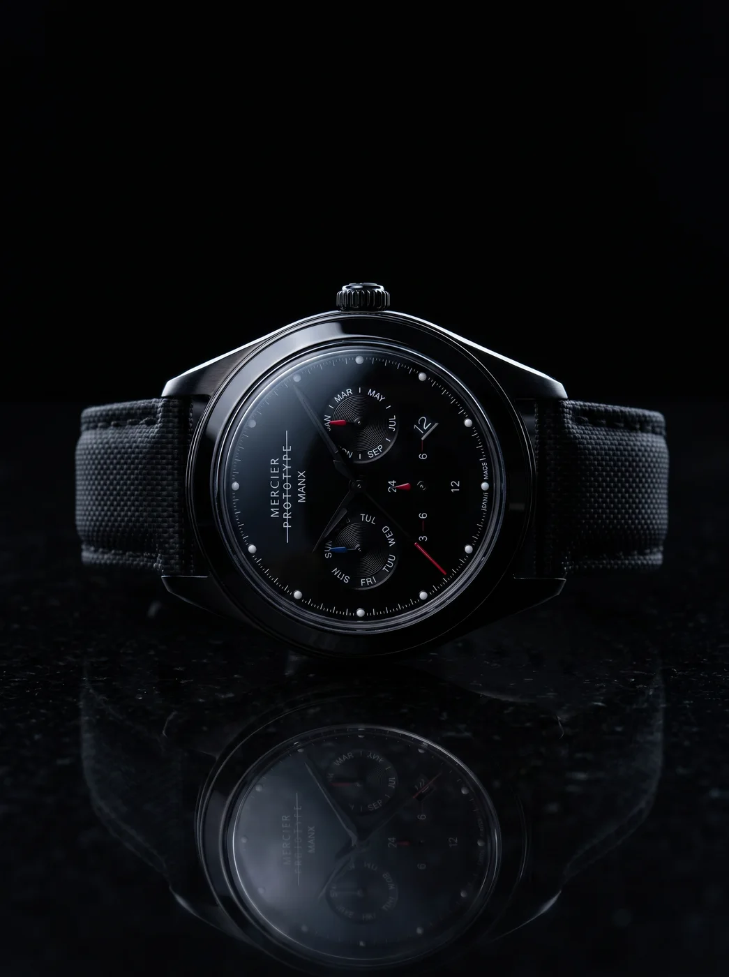 Manx Meridian Noir rim-lit on black stone